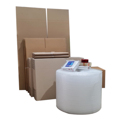 A collection of cardboard moving packing boxes in various sizes, with packing materials and a roll of packing tape.