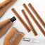 A series of brown kraft paper expanding glass bottle sleeves with a honeycomb pattern, designed to protect wine bottles, laid out on a white surface.
