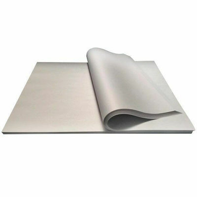 A sheet of butchers paper partially covering another sheet, displaying a smooth white surface.