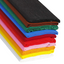 Stack of folded crepe paper sheets in various colors including pink, light blue, dark blue, purple, black, brown, lime, green, orange, yellow, white, and red.
