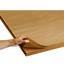 A person's hand holding a stack of brown kraft paper sheets.