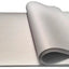 A roll of white butcher's paper unrolling to show its length, with a focus on its thickness and texture.