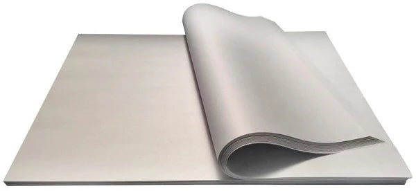 A roll of white butcher's paper unrolling to show its length, with a focus on its thickness and texture.