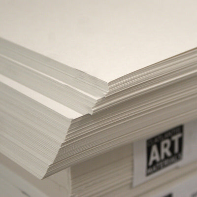 A stack of white cartridge drawing paper sheets, with the top sheet slightly lifted to show the texture. The paper is acid-free, indicated by the 'Arts & Crafts' branding at the bottom.