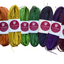 A collection of raffia strings in various colors bundled together, labeled with the brand name.