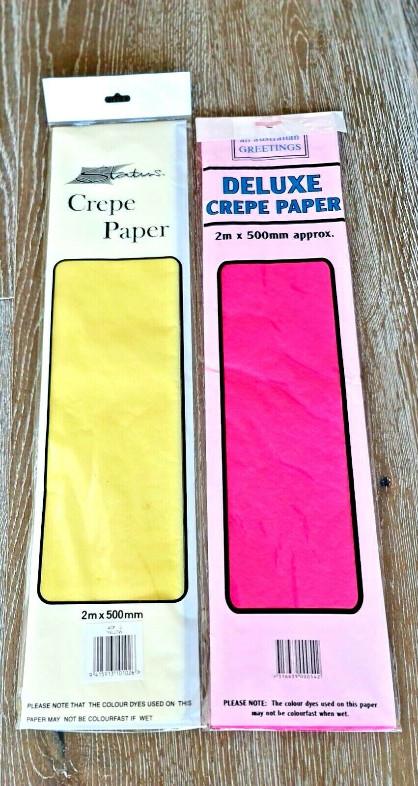 Packaging of deluxe crepe paper in pink and yellow colors, each pack is 500mm x 2m.