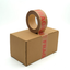 A roll of brown cardboard shipping tape with red 'FRAGILE' text, shown partially unrolled over a brown cardboard box on a white background.