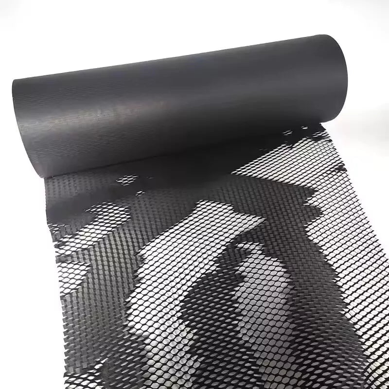 Rolls of honeycomb kraft paper bubble wrap in various colors including beige, red, black, and white, with some rolls unrolled to show the honeycomb pattern.