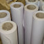 Rolls of white butcher's paper stored in a warehouse setting.