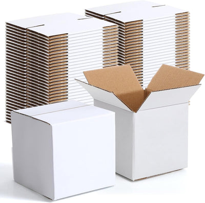 A stack of white shipping boxes with one box partially opened, showing the inside compartment.