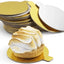 Small dessert with meringue on a gold plate, surrounded by additional gold plates.