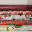 Stack of Christmas-themed wrapping paper rolls on a white background