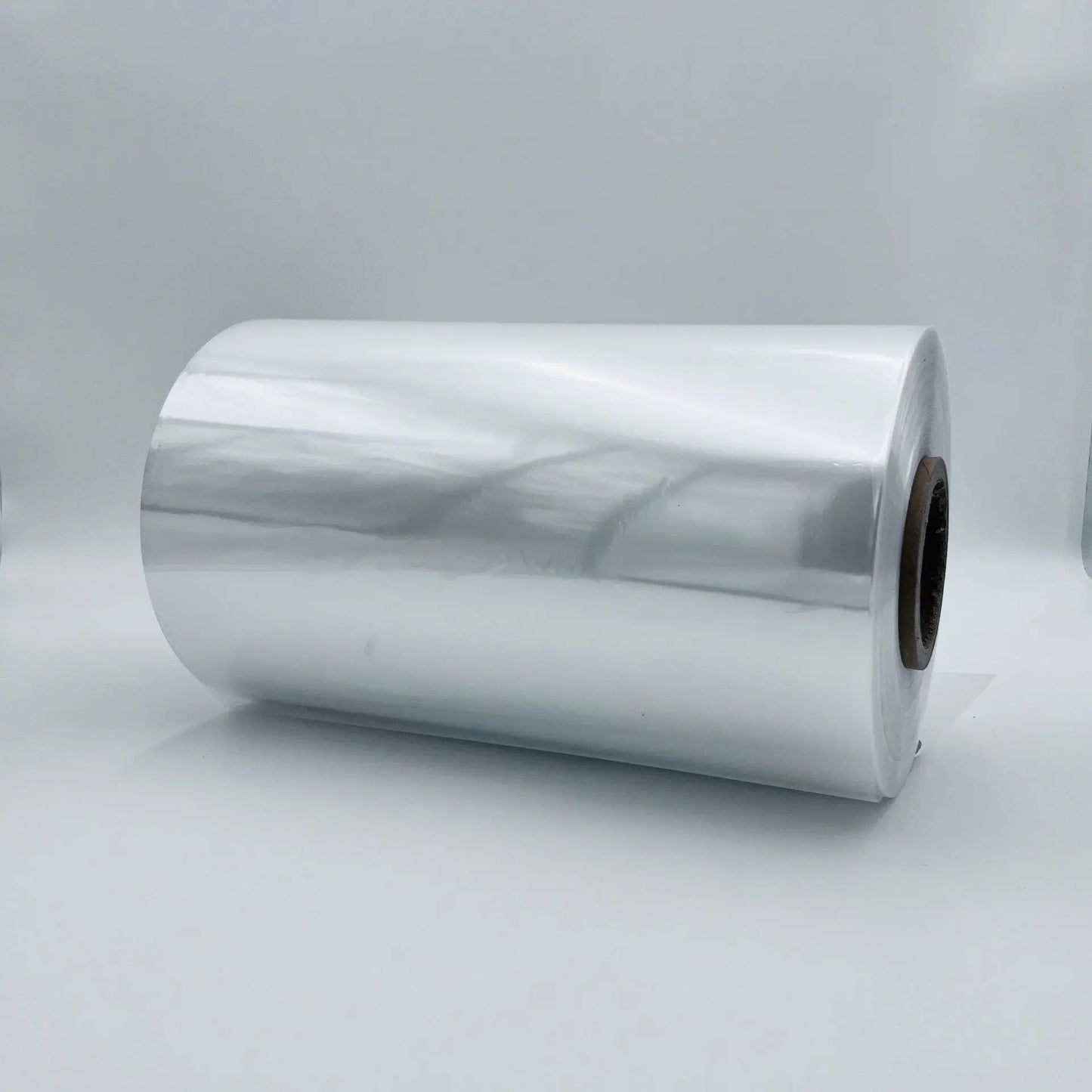 Roll of reflective silver material on a white background